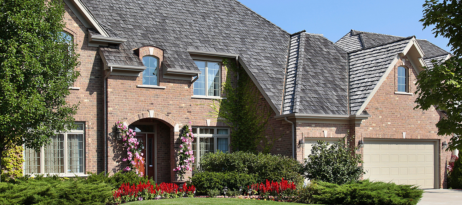 Exterior of a large suburban brick home during a home inspection